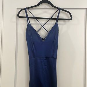 In New condition. Worn once and dry cleaned. It’s dark blue with satin texture,